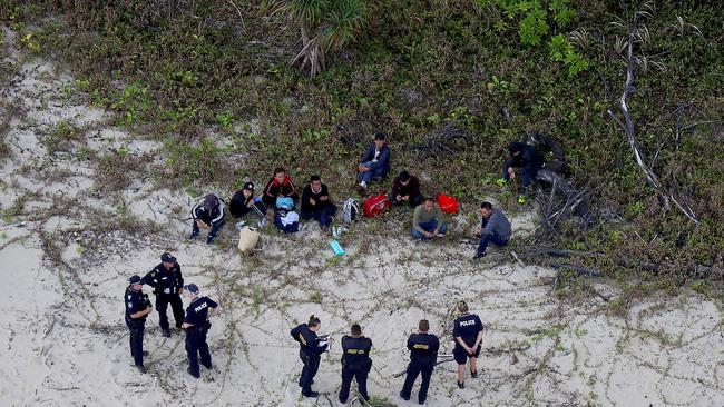 NO ONLINE UNTIL ROLLOVER - BCM News - 26/08/18 - Police and Border Force officers guard nine asylum seekers who sunk their fishing boat today off Cape Kimberley in North Queensland. PICTURE: MARC MCCORMACK