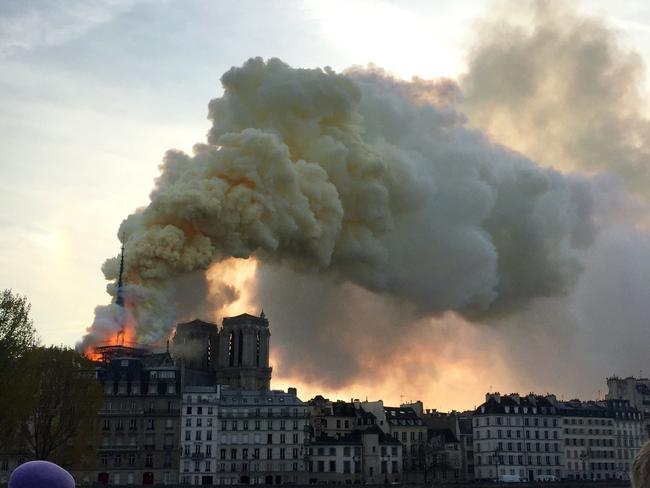 Flames and smoke are seen billowing from the roof at Notre-Dame Cathedral in Paris on April 15, 2019. (Photo by Fouad Maghrane / AFP)