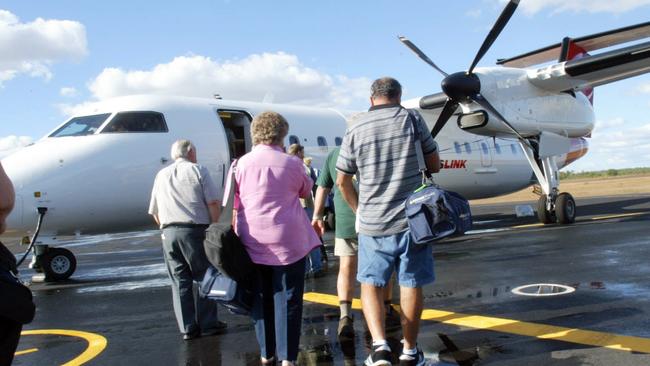 All aboard. Passengers board a QantasLink Dash 8 like that involved in Monday’s incident in Canberra Picture: News Corp Australia