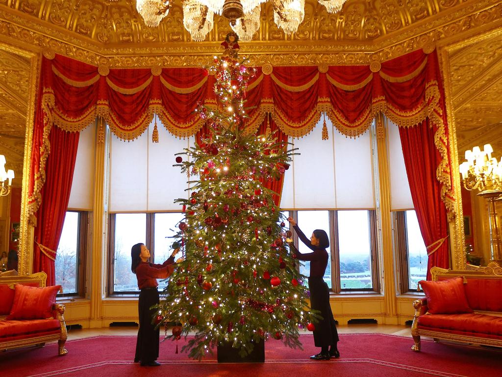 Royal household staff decorate a Christmas tree at Windsor Castle. Picture: Getty Images