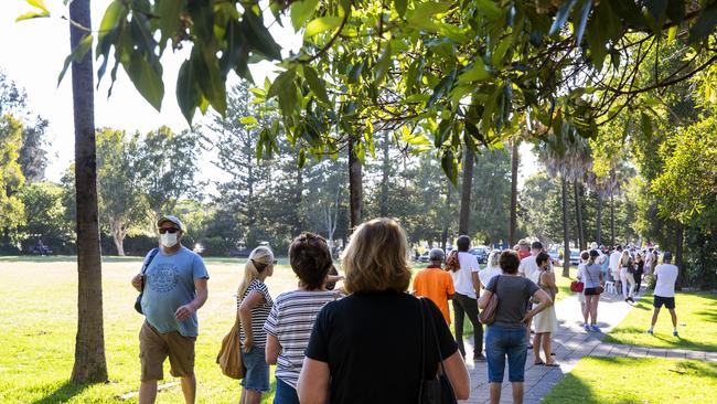 People are seen lining up at a COVID-19 pop-up testing location at Avalon Recreation Centre on December 18, 2020 in Sydney, Australia. A cluster of COVID-19 cases on the northern beaches of Sydney has grown to 17, prompting NSW health officials to urge residents of affected suburbs to stay home. The source of the cluster is not known. (Photo by Jenny Evans/Getty Images)