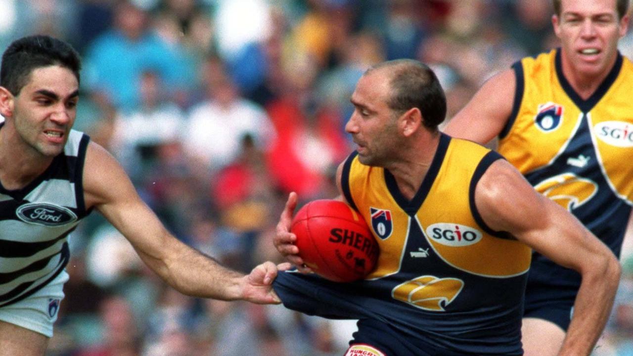 Peter Matera evades a tackle attempt from Geelong’s Ronnie Burns.