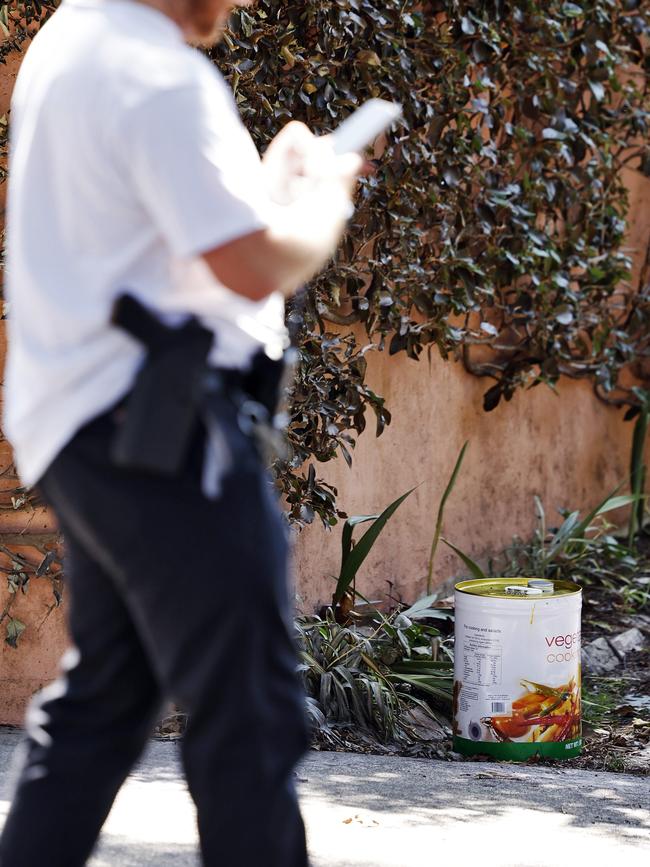 After police leave the scene a 20L tin containing what smells like petrol sits next to where the car was burning. Police return to inspect it after being called by the media. Picture: Sam Ruttyn