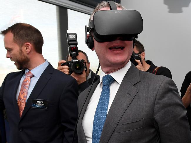 Defence Industry Minister Christopher Pyne tries out a VR headset at Lockheed Martin in Melbourne. AAP Image/Joe Castro