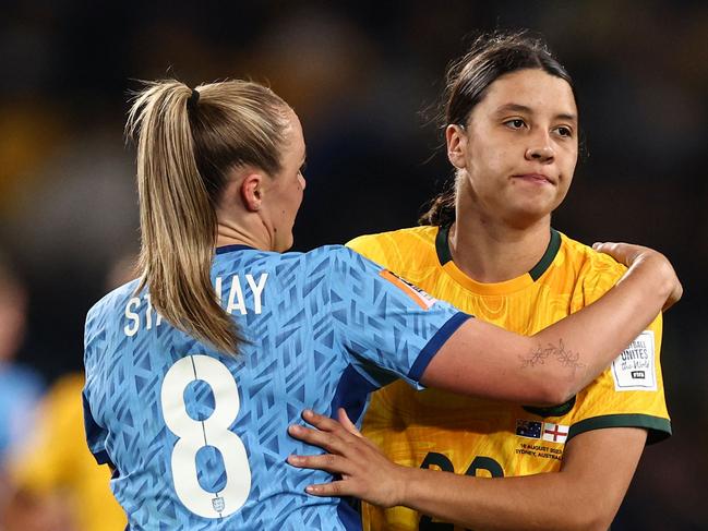 TOPSHOT - England's midfielder #08 Georgia Stanway embraces Australia's forward #20 Sam Kerr at the end of the Australia and New Zealand 2023 Women's World Cup semi-final football match between Australia and England at Stadium Australia in Sydney on August 16, 2023. (Photo by FRANCK FIFE / AFP)