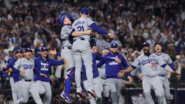 The Los Angeles Dodgers celebrate as they defeat the New York Yankees 7-6. (Photo by Elsa/Getty Images)