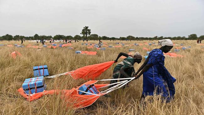 Villagers in South Sudan collect rations parachuted from a plane. Picture: Getty Images