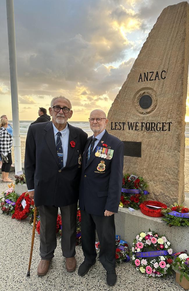 Surfers Paradise RSL sub-branch committee member and Anzac Day service flag marshal David Stoneley (left) with sub-branch secretary and treasurer Charles Wright at the Surfers memorial after the dawn service.