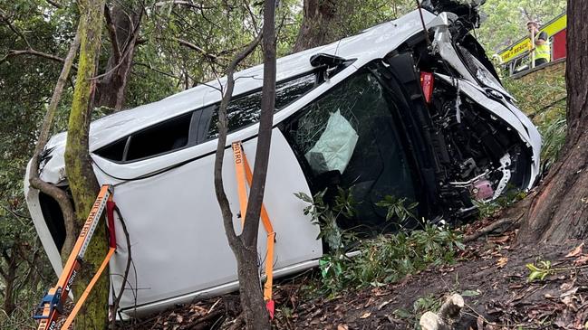 A man in his 80s has been rescued from his car after it rolled down an embankment during wet weather conditions in Mosman, Sydney. Picture: Fire and Rescue NSW