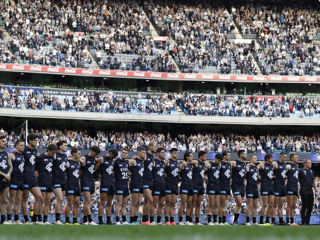 The crowd stands in silence for the Anzac ceremony. Picture: Michael Klein