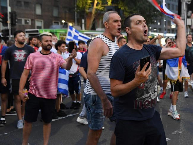 Supporters of Serbia's Novak Djokovic confront the police after a car left the building in Melbourne after the tennis champion earlier in the day won a court battle to overturn the cancellation of his visa. Picture: AFP