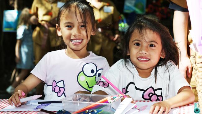 Khye Daruca, 6, and Kiki Daruna, 5, colour in butterflies at the creation station at the Cairns Children's Festival, held at the Tanks Arts Centre, Edge Hill. Picture: Brendan Radke