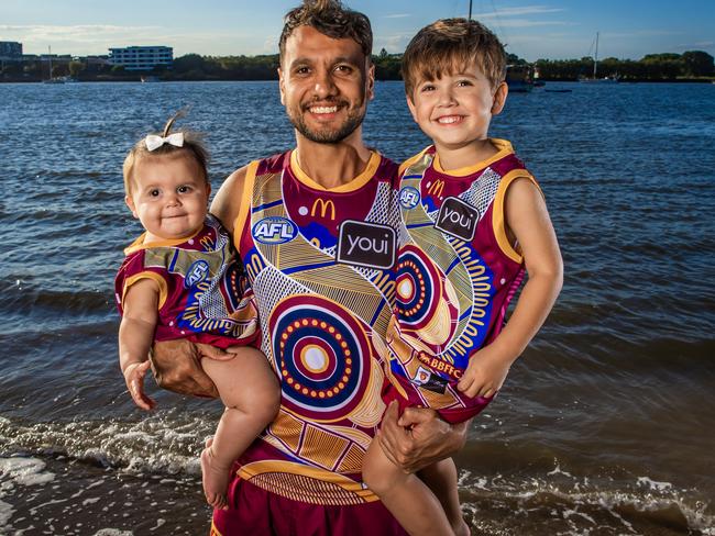 Callum Ah Chee and his children Daisy, 10 months, and Iver, 3, proudly wear the Lions’ Indigenous guernsey. Picture: Nigel Hallett
