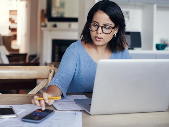 MONEY ISTOCK -  Shot of a young woman using a laptop and calculator while working from home Picture: Istock