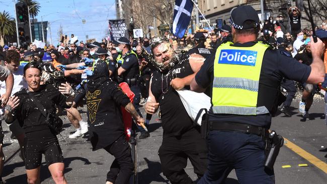 Police pepper spray protesters during an anti-lockdown rally in Melbourne on Saturday. Picture: Getty