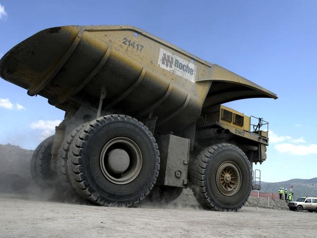 A large dump truck dwarfs a nearby vehicle as it drives at the Excel Coal Limited's Wambo Coal Mine in Hunter Valley, Australia. Australian exports rose to the second highest on record in October, narrowing the trade deficit more than expected, as miners including Portman Ltd. and BHP Billiton earned more from commodity shipments to China. Photographer: Michael Caronna/Bloomberg News.