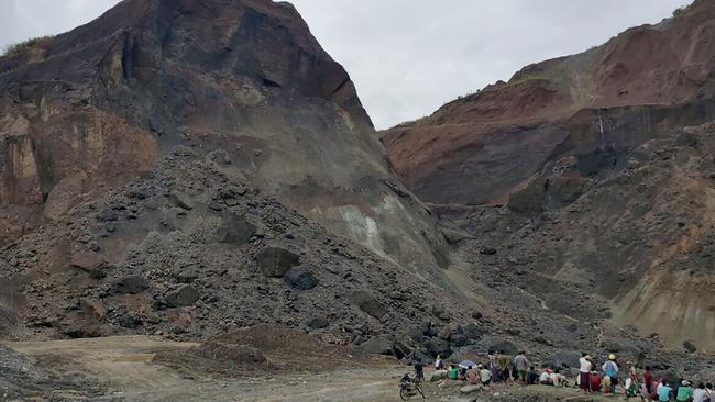 Rescue workers gather beside a landslide in a jade mining area on the outskirts of Hpakant in Myanmar's northern Kachin state. Picture: AFP/Kyaw Win