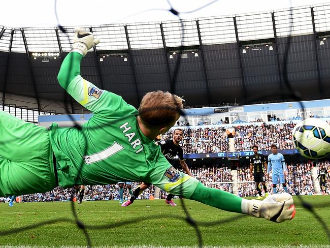 Joe Hart dives to his right to keep Roberto Soldado’s penalty out.