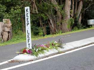 Flowers on Cecil St, Nimbin, where a pedestrian was fatally struck by a vehicle in an alleged hit-and-run incident overnight. Picture: Liana Turner