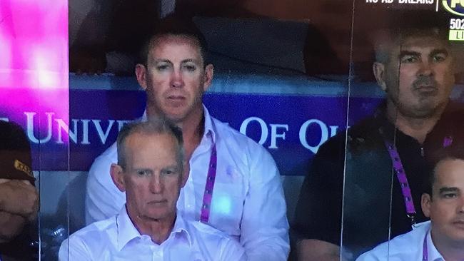 Former Brisbane official and player Andrew Gee (right) in the Broncos' coaches box during the elimination final loss the St George Illawarra.