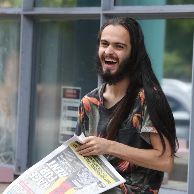 Eric Serge Herbert catches up with the latest in The Daily Telegraph outside Burwood Court. Picture: John Grainger