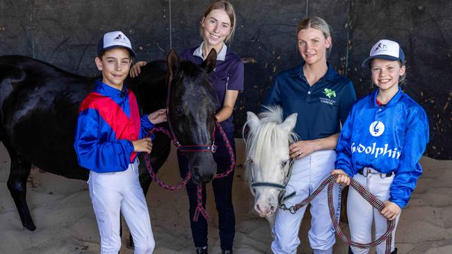 Jamie Kah (second from right) joins in with the pony racing kids Harry Downer, 10, Monique Maund, Jamie Kah and Ella Bowen with pony Sapphire (black) and Sapphire’s paddock buddy Spirit. Picture: Russell Millard Photography