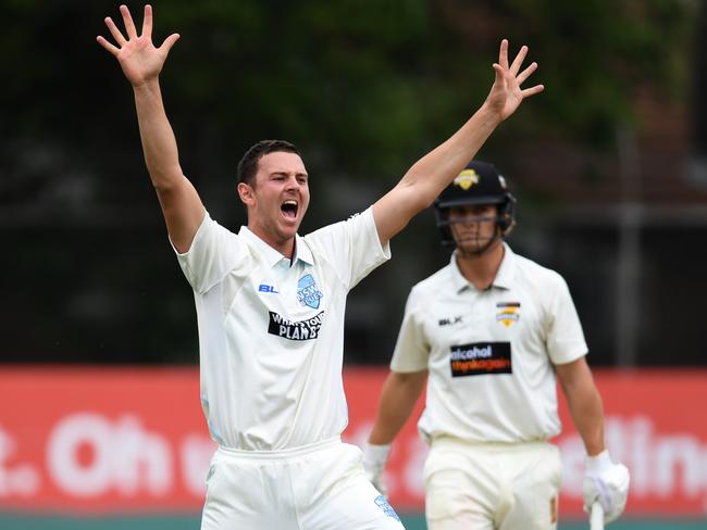 Josh Hazlewood traps Hilton Cartwright in front.