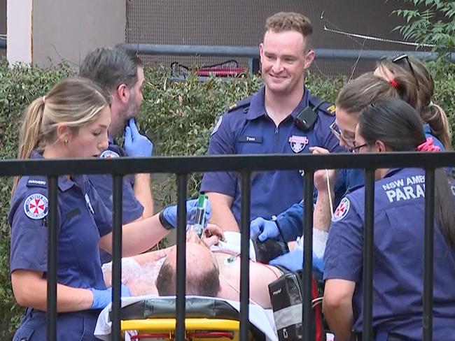 Paramedics treat the injured man. Picture: TNV