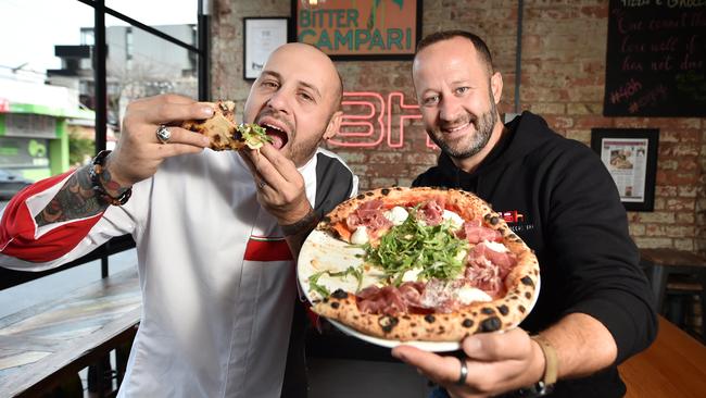 48h Pizza e Gnocchi Bar’s Michele Circhirillo and Fabio Biscalddi sink their teeth into something delicious. Picture: Nicki Connolly