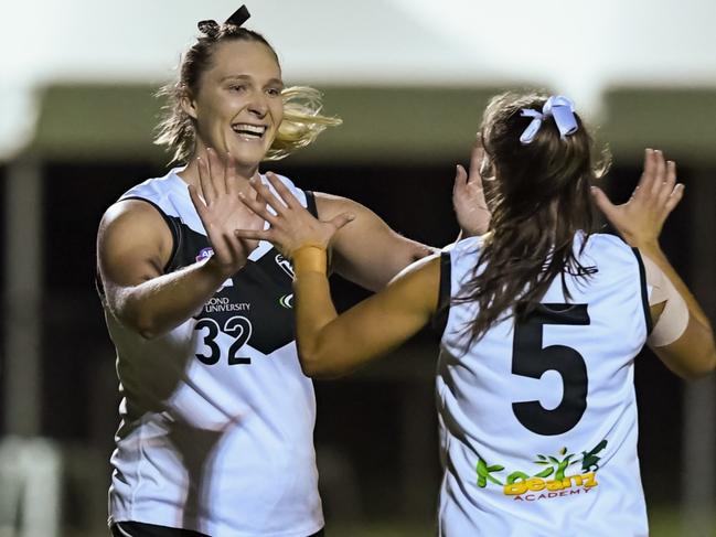 Southport Sharks player Tayla Gregory (32) celebrates with captain Jess Malouf (5) in the QAFLW Southport Sharks v Bond University match, Round 4, 2023. Deion Menzies/Highflyer Images