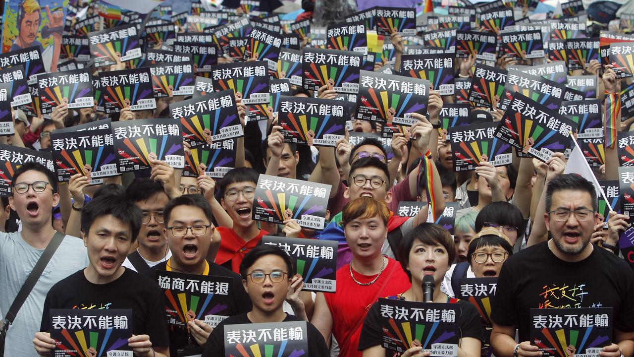 Hundreds of gay rights supporters gathered despite heavy rain near Taipei’s parliament. Picture: Chiang Ying-ying/AP