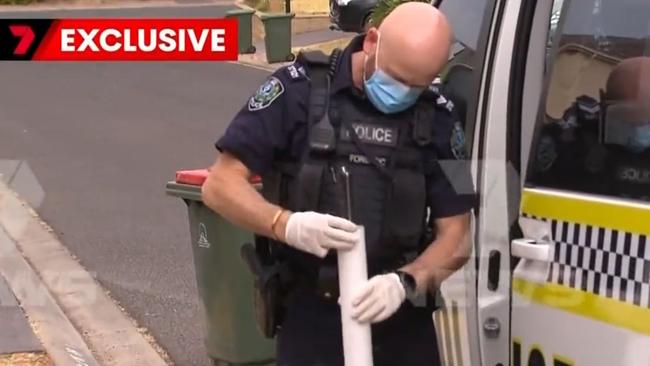 A police officer with evidence after the three boys were arrested. Picture: 7NEWS