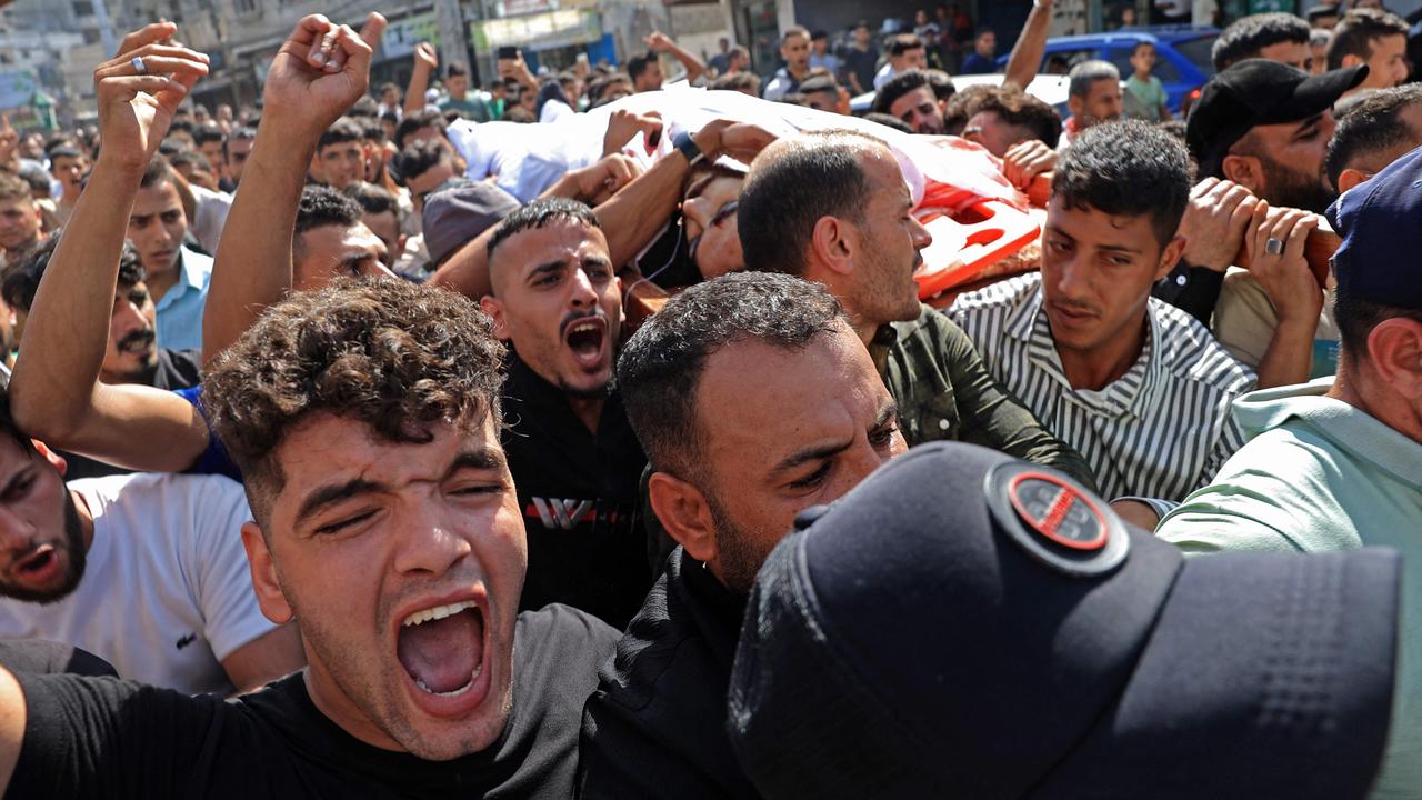 Palestinians carry the body of a victim that was killed in an Israeli strike, in Khan Yunis in the southern Gaza Strip. Picture: Said Khatib / AFP