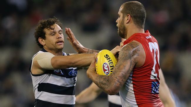 Motlop grapples with Lance Frankling during the Cats’ loss.  Picture: Wayne Ludbey