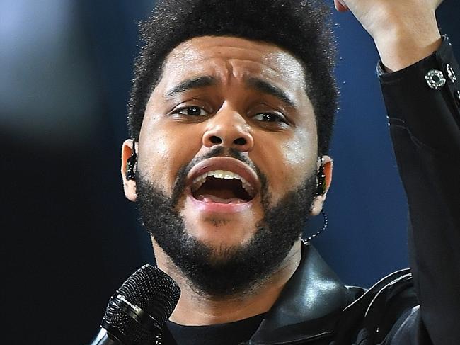 PARIS, FRANCE - NOVEMBER 30:  The Weeknd sings on the runway during the 2016 Victoria's Secret Fashion Show on November 30, 2016 in Paris, France.  (Photo by Dimitrios Kambouris/Getty Images for Victoria's Secret)