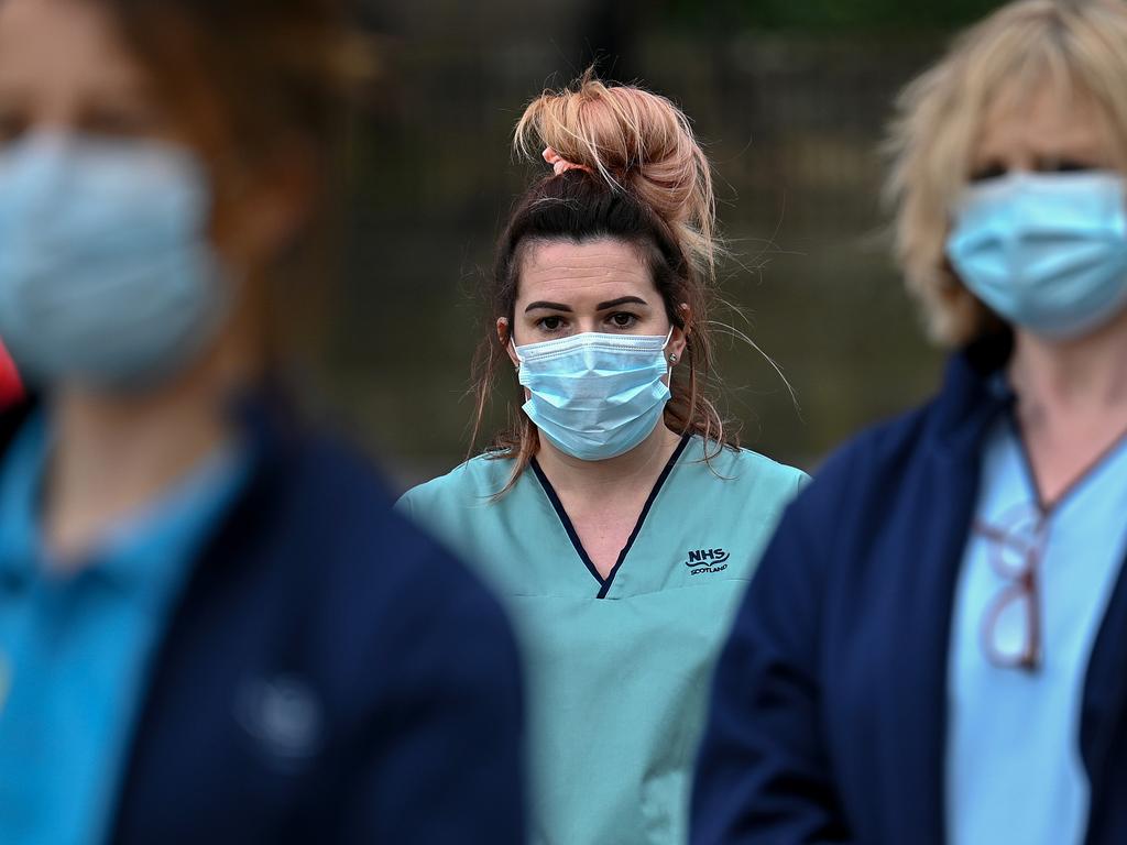 Staff from the Glasgow Royal Infirmary gather outside the hospital for a minute’s silence on March 23. Picture: Jeff J Mitchell/Getty Images