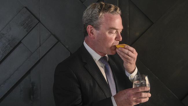 Christopher Pyne sucks on a lemon at the launch of his new business venture at the 2KW bar in Adelaide on Wednesday. Picture: Roy VanDerVegt