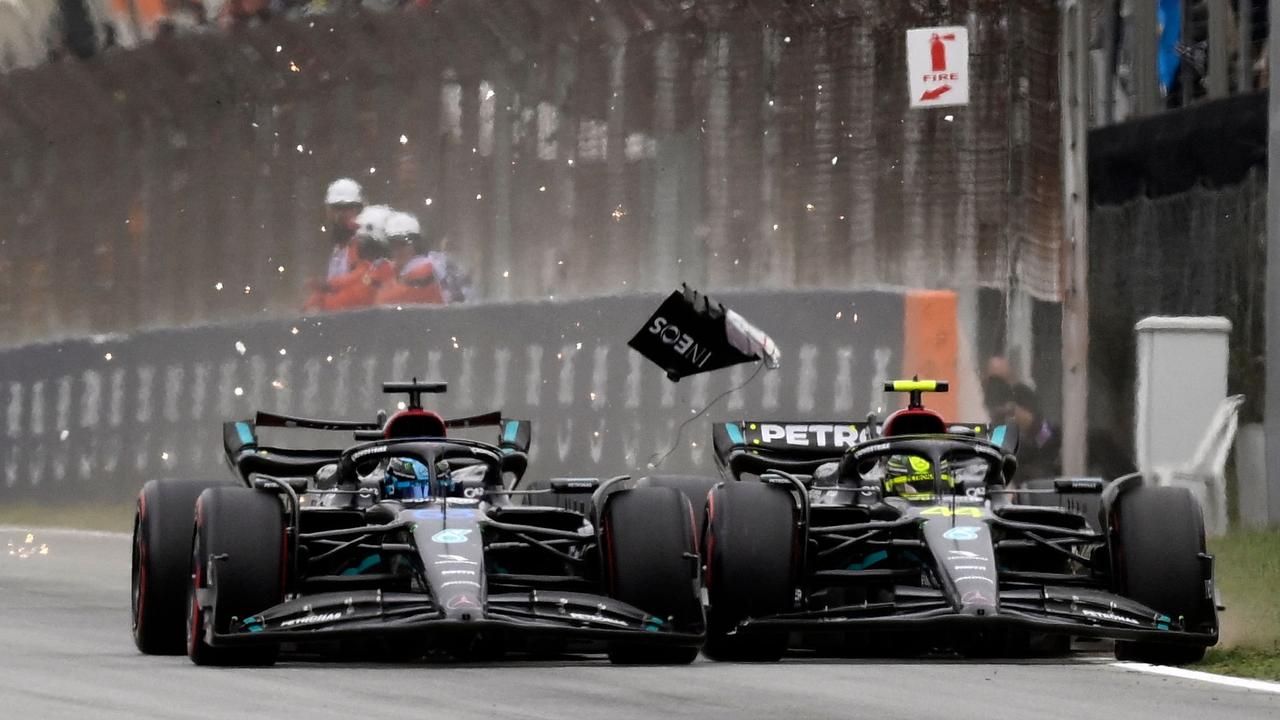 George Russell and Lewis Hamilton make contact. Photo by Josep LAGO / AFP.