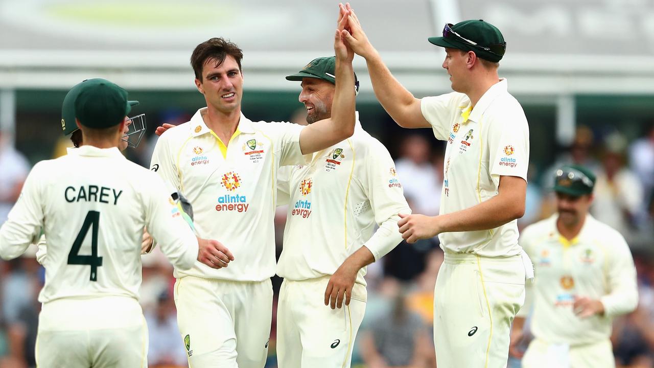 BRISBANE, AUSTRALIA - DECEMBER 08: Australian captain Pat Cummins celebrates dismissing Mark Wood of England during day one of the First Test Match in the Ashes series between Australia and England at The Gabba on December 08, 2021 in Brisbane, Australia. (Photo by Chris Hyde/Getty Images)