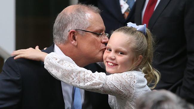 Treasurer Scott Morrison kisses daughter Abbey after delivering his Budget speech. Picture: Kym Smith