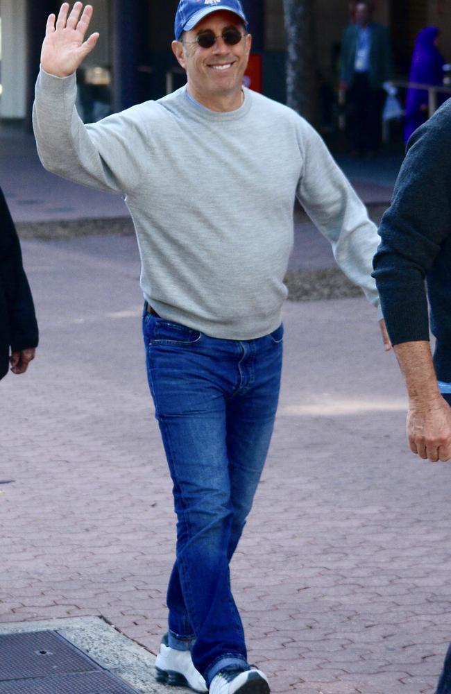 Wonder if those white sneakers were cleaned at the Mom and Pop Store? Jerry Seinfeld goes for stroll with a friend around Olympic Park. Picture: Mega