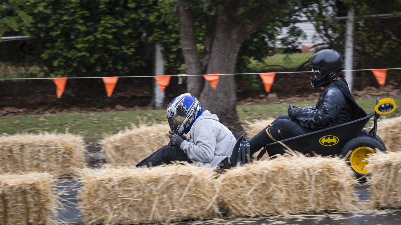 Ashton Reedy is too fast for Batman aka Doug Gale in a senior class of the Greenmount Billy Cart Challenge, Saturday, November 25, 2023. Picture: Kevin Farmer