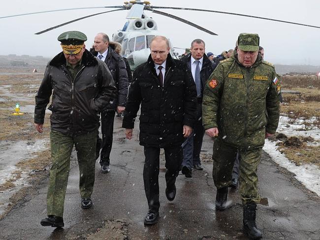 Vladimir Putin and Defence Minister Sergei Shoigu arrive to watch military exercises at the Kirillovsky firing ground in the Leningrad region as tensions rise in the Ukraine.