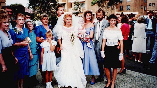 Missing mother Bronwyn Winfield with relatives in 1990. From left: Cousin Alison, Bronwyn's mother Barbara Read, Bronwyn's grandmother Billie Hain, cousin Jayne Drewitt, Bronwyn's daughter Chrystal, front, Michelle Read, in bridal gown, Bronwyn's brother Andrew Read, groom, Bronwyn Winfield, holding baby Lauren, and Jon Winfield, with his arm around his daughter Jodie.