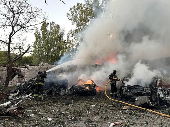 This handout photograph taken and released by the Ukrainian Emergency Service shows rescuers working at the site of a missile attack in Zaporizhzhia. Picture: Handout / AFP