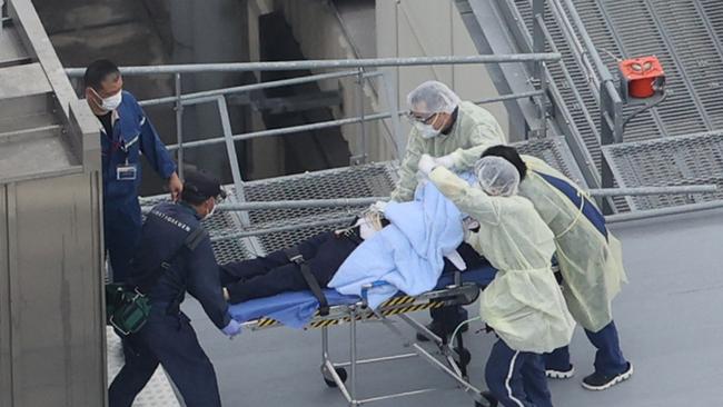 Mr Abe is pictured on a stretcher at Nara Medical University Hospital in Kashihara, Nara Prefecture.