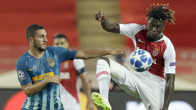 Monaco midfielder Kevin Ndoram controls the ball as Atletico midfielder Koke looks on. Picture: AP