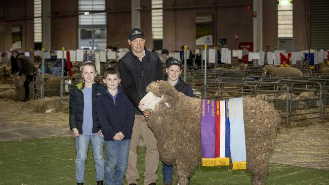 Supreme Champion Merino sheep: L-R 10yo Lily, 8yo Will, Tim, and 12yo Harry Dalla with merino ram from Collinsville at Hallett SA. Picture: Zoe Phillips