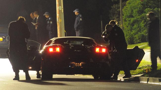 Police inspect the scene where Fadi Ibrahim, 35, was shot five times and his 23-year-old partner was hit in the leg as they sat in his parked Lamborghini.