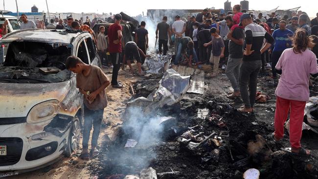 Palestinians gather at the site of an Israeli strike on a camp for internally displaced people in Rafah.